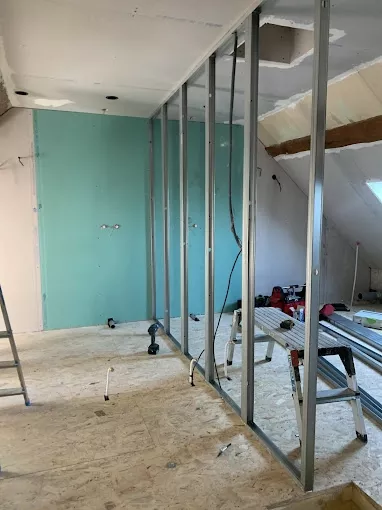 Cloison en plaques de plâtre en cours de pose pour aménagement intérieur lors de travaux de rénovation